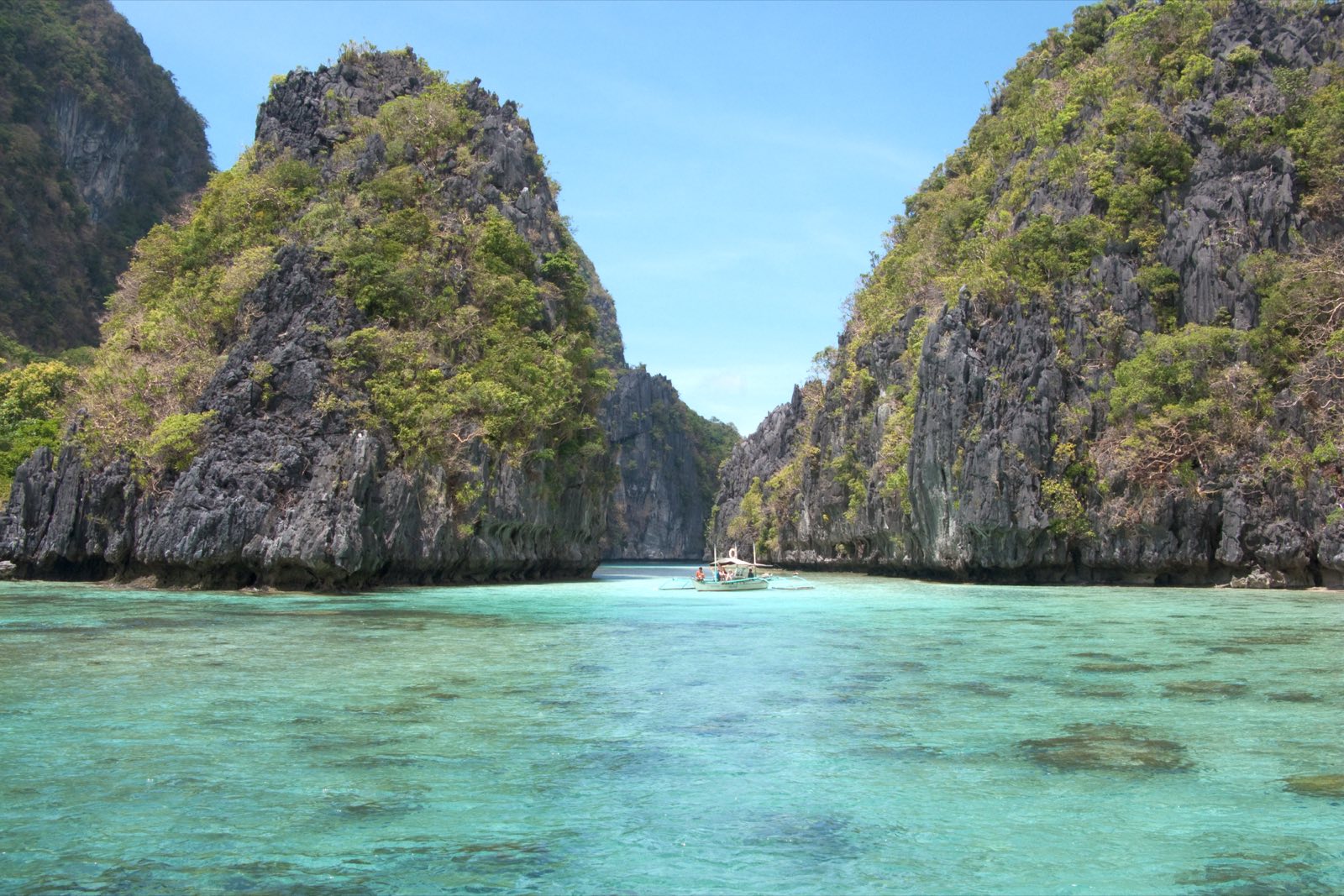 Karst towers guarding the entrance to a turquoise island lagoon in Bacuit Bay, El Nido